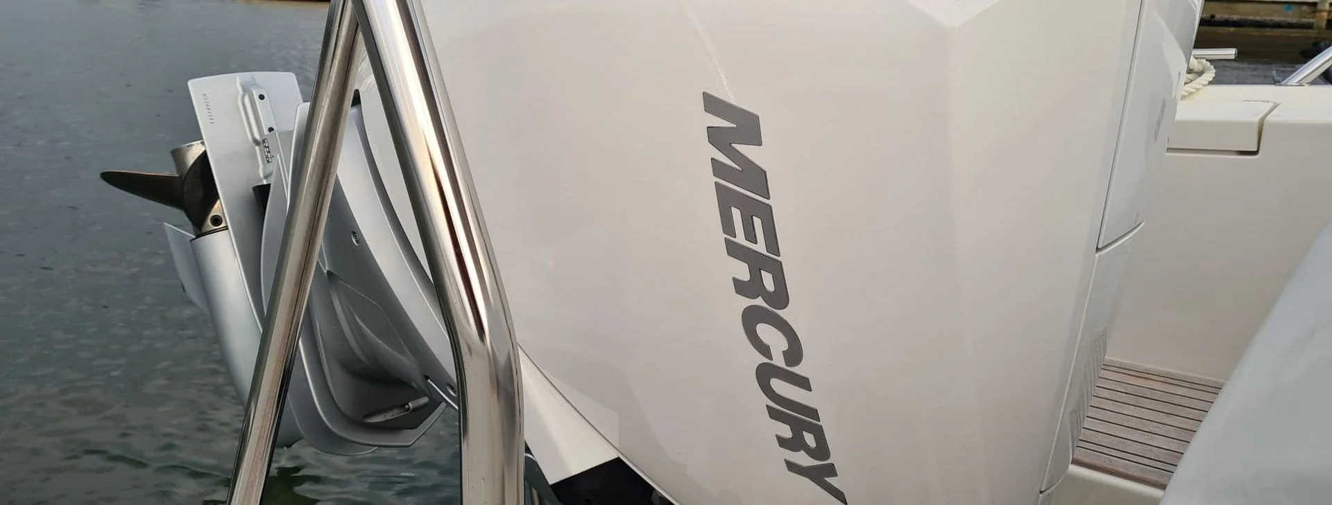 White recreational boat hull with brand nameplate visible at dock in St. Petersburg.