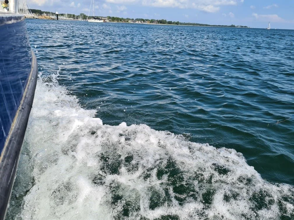 Boat hull with heavy marine growth and barnacle buildup viewed from waterside in St. Petersburg.