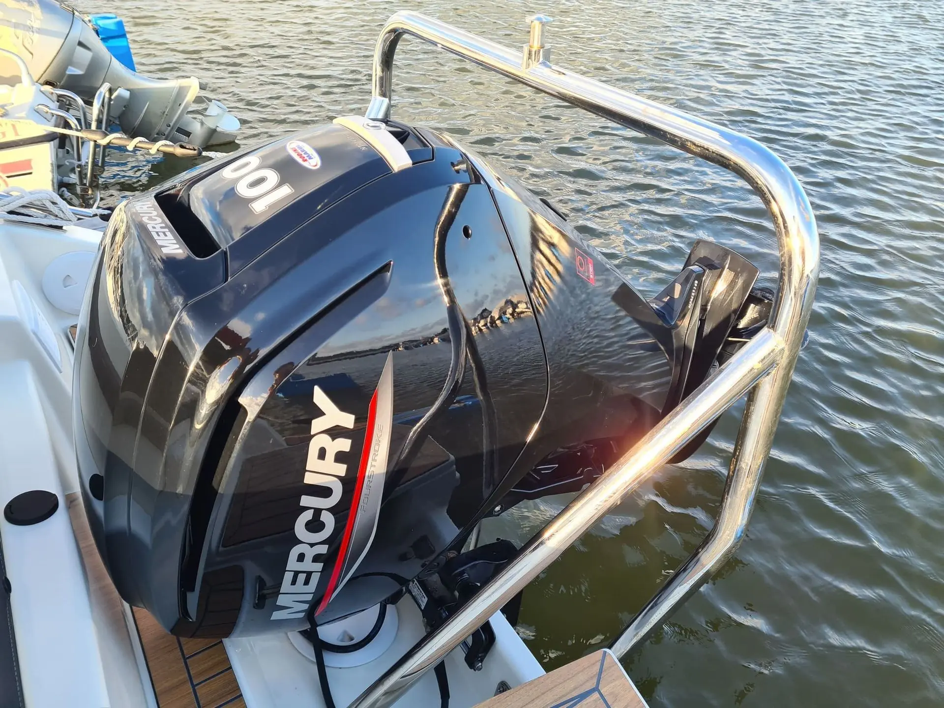 Mercury outboard motor mounted on boat transom at floating dock in St. Petersburg waters.
