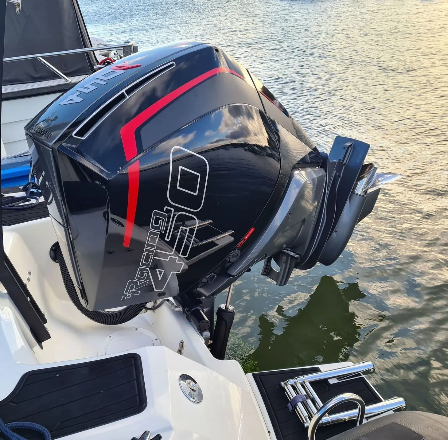 High-horsepower outboard motor mounted on boat transom at waterside dock in St. Petersburg.