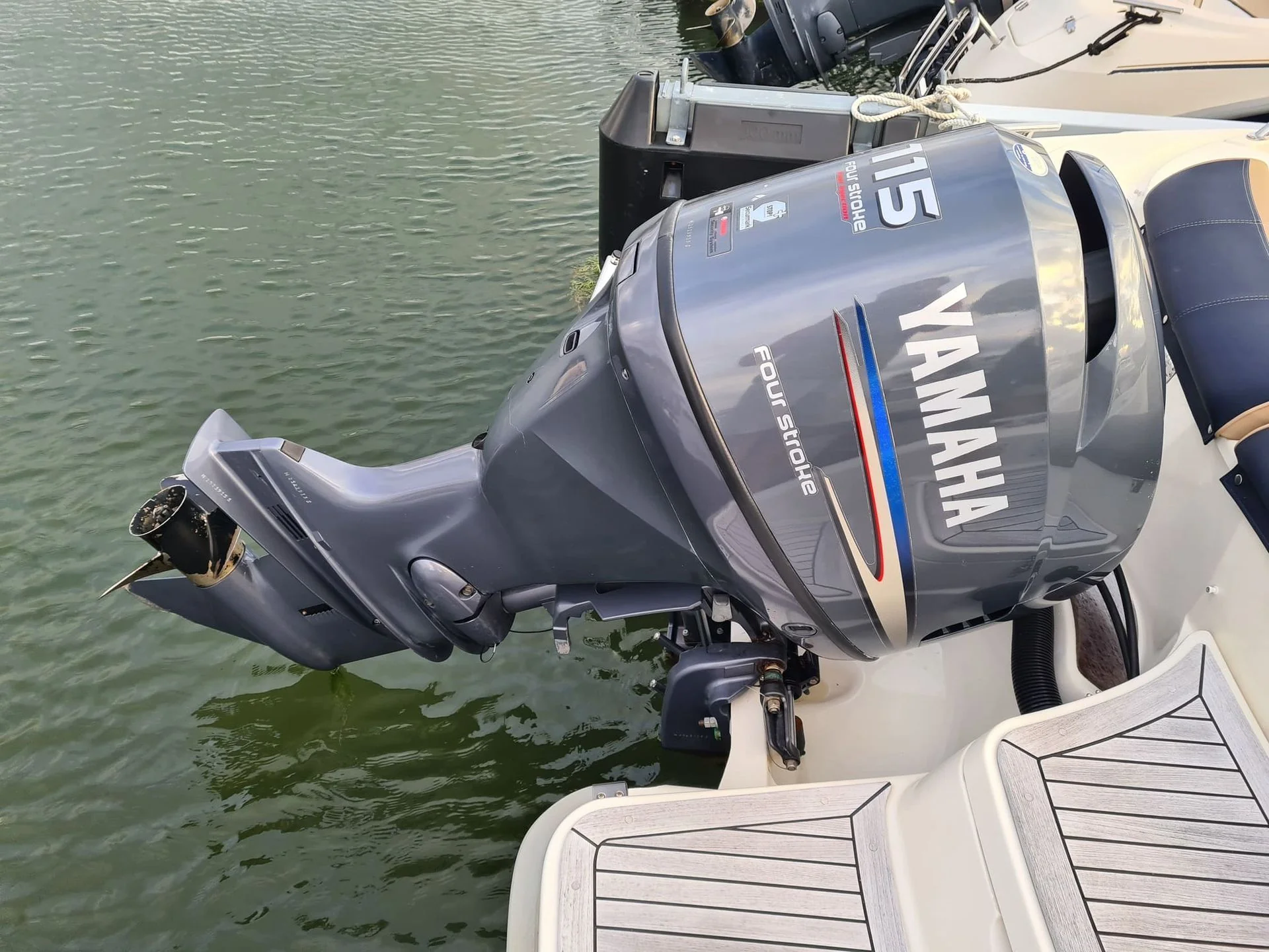 Outboard motor mounted on boat transom at waterside dock in St. Petersburg.